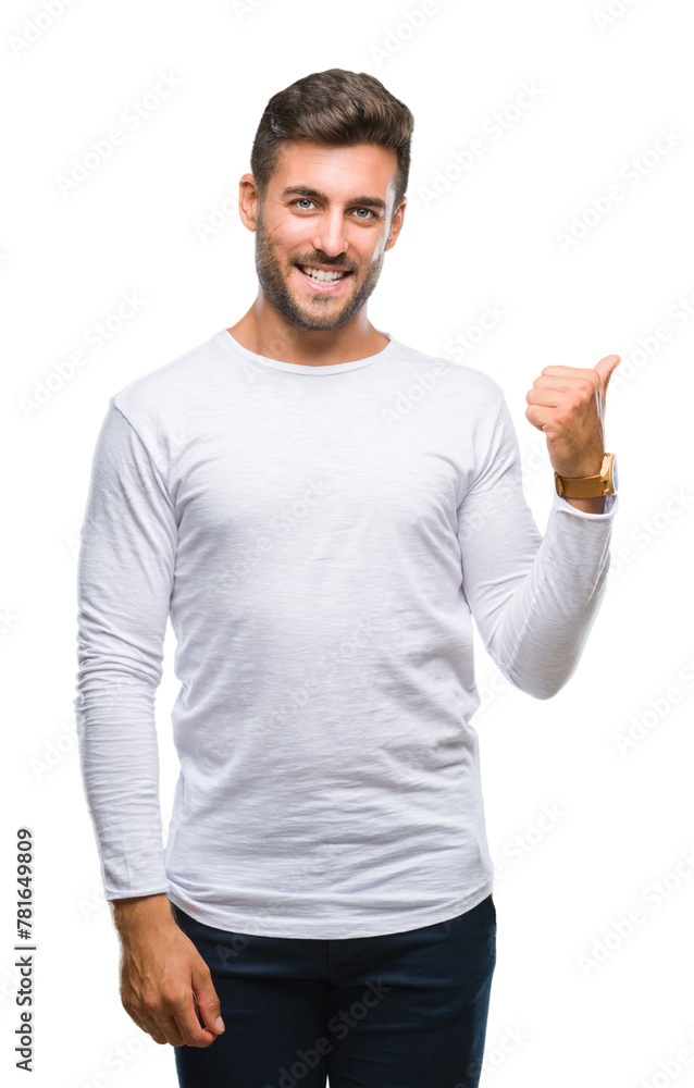 Young handsome man over isolated background smiling with happy face looking and pointing to the side with thumb up. Young handsome man over isolated background smiling with happy face looking and pointing to the side with thumb up.