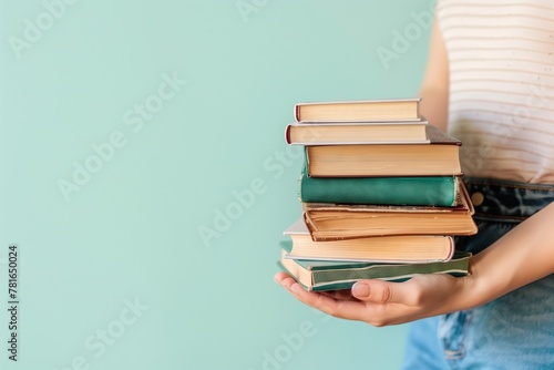 Educational Insight: Woman's Hands Clutch Stack of Books, Conveying Education, Science, Knowledge, and Intellectual Curiosity