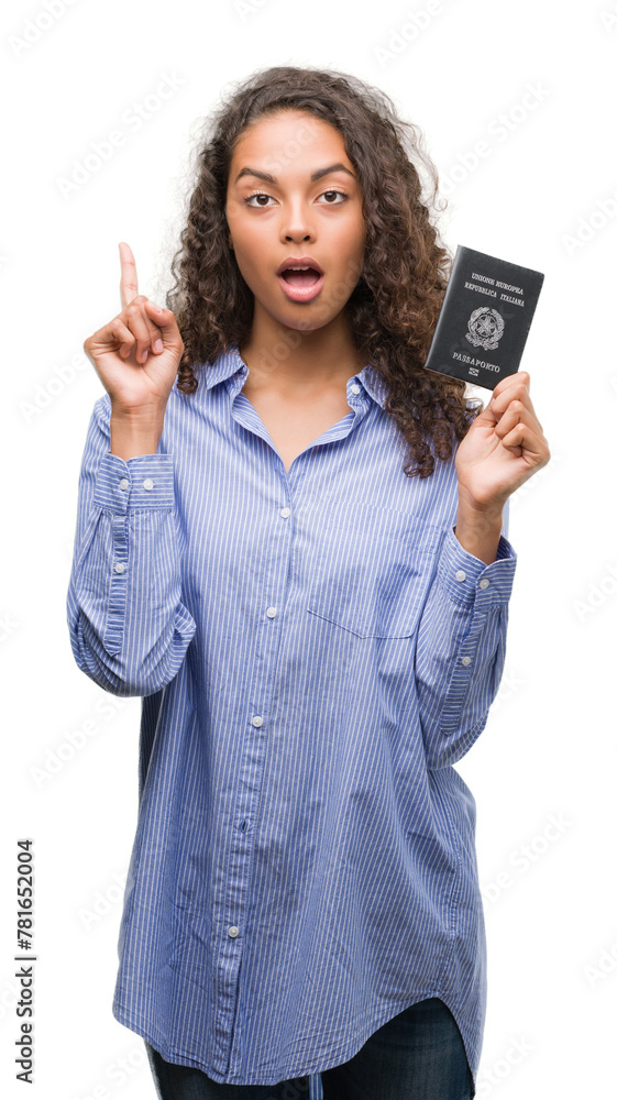 Obraz premium Young hispanic woman holding passport of Italy surprised with an idea or question pointing finger with happy face, number one