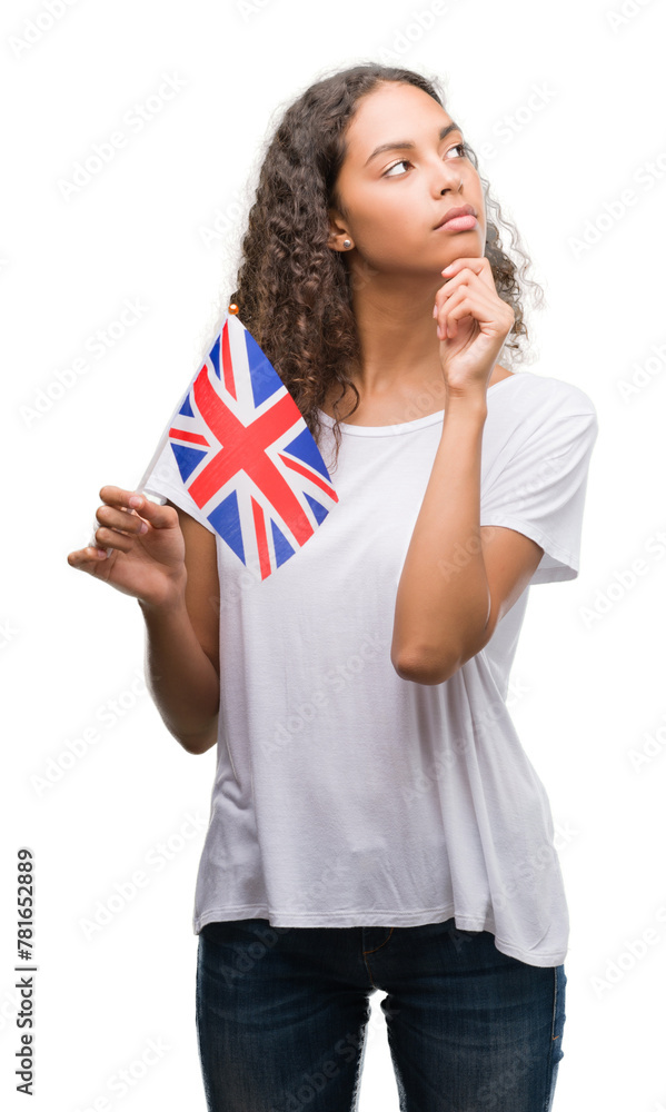 Young hispanic woman holding flag of United Kingdom serious face thinking about question, very confused idea Young hispanic woman holding flag of United Kingdom serious face thinking about question, very confused idea