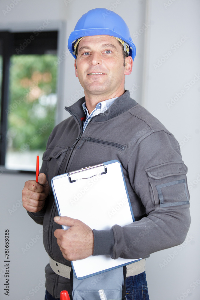 confident bearded builder man wearing overalls and hardhat standing confident bearded builder man wearing overalls and hardhat standing
