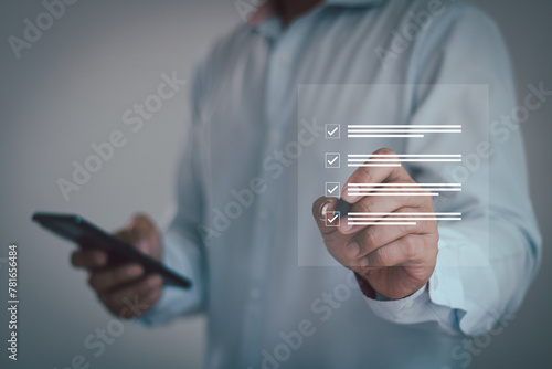Business performance checklist. Businessman using smartphone do online checklist survey, filling out digital form checklist, take an assessment, questionnaire, evaluation, online survey, online exam.
