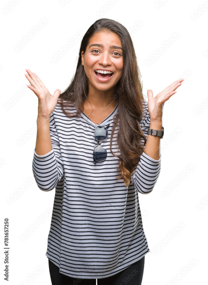 Young beautiful arab woman wearing sunglasses over isolated background celebrating crazy and amazed for success with arms raised and open eyes screaming excited. Winner concept Young beautiful arab woman wearing sunglasses over isolated background celebrating crazy and amazed for success with arms raised and open eyes screaming excited. Winner concept