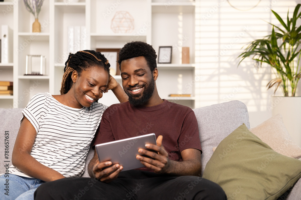 Couple Enjoying Quality Time With Tablet In Cozy Living Room Couple Enjoying Quality Time With Tablet In Cozy Living Room