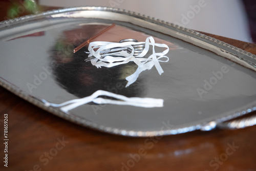 elegant silver tray with wedding hairpin and ribbons on wooden surface