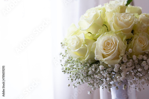 fresh bouquet of white roses with baby's breath on display