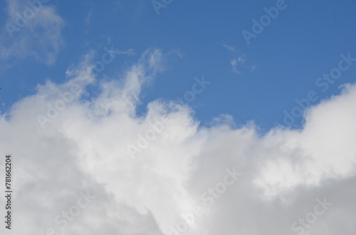 Clouds in a bright blue sky at midday