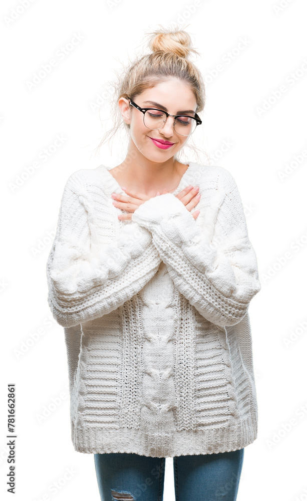Young beautiful blonde woman wearing glasses over isolated background smiling with hands on chest with closed eyes and grateful gesture on face. Health concept.