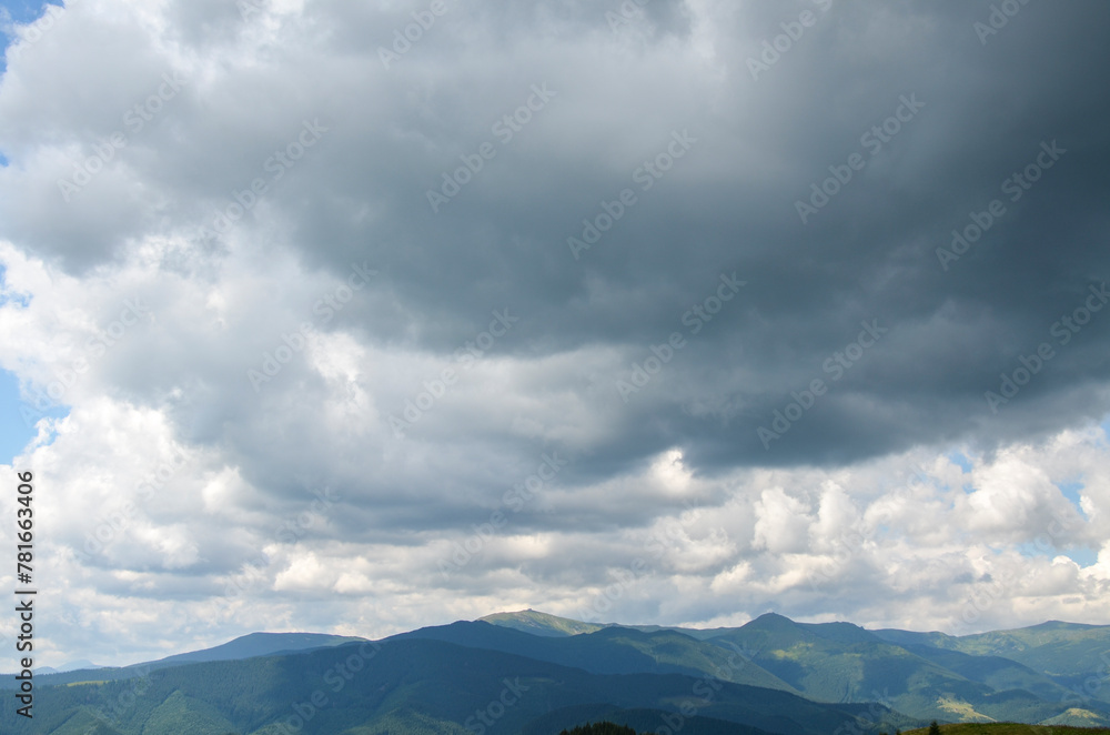 A serene and captivating landscape showcasing the majestic beauty of a mountain range with highest peak Pip Ivan with observatory enveloped in the soft embrace of cloudy skies. Carpathians, Ukraine
