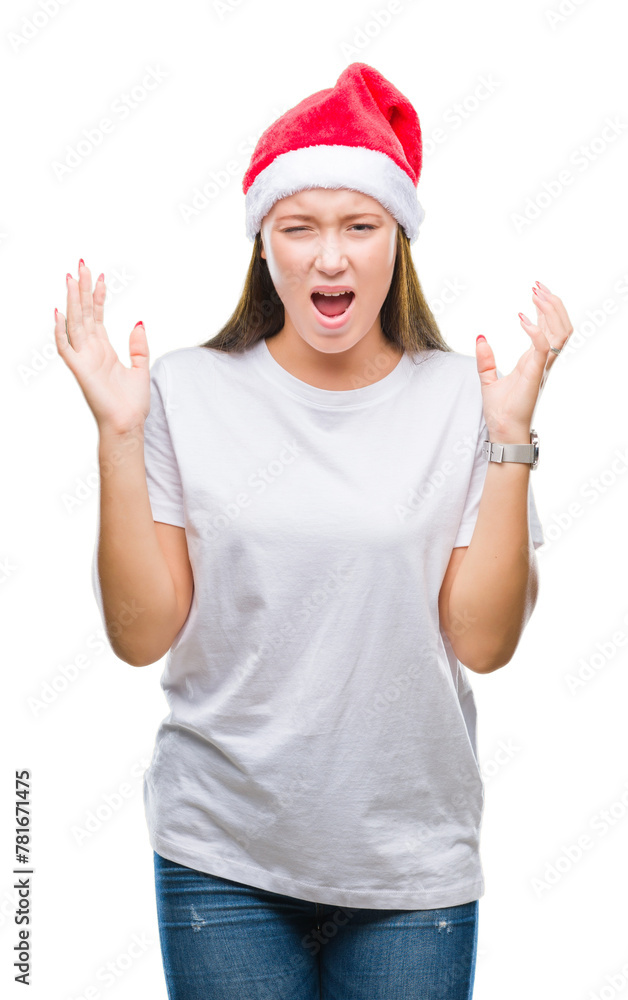 Young beautiful caucasian woman wearing christmas hat over isolated background celebrating mad and crazy for success with arms raised and closed eyes screaming excited. Winner concept Young beautiful caucasian woman wearing christmas hat over isolated background celebrating mad and crazy for success with arms raised and closed eyes screaming excited. Winner concept
