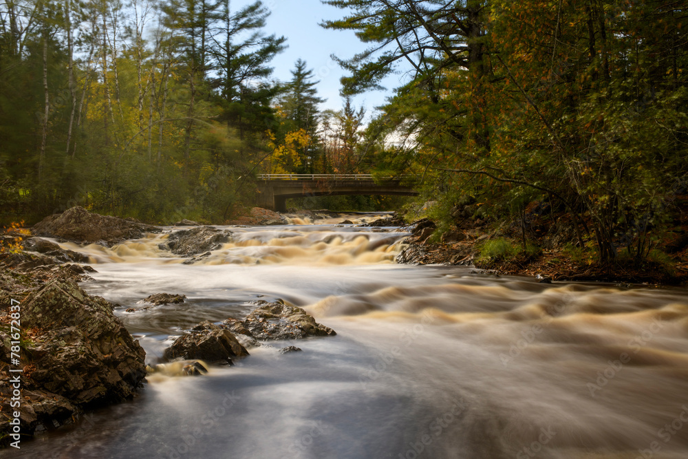 Long exposure of a wilderness river with bridge Long exposure of a wilderness river with bridge