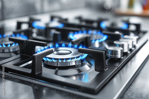 Silver gas stove with blue flame in modern kitchen