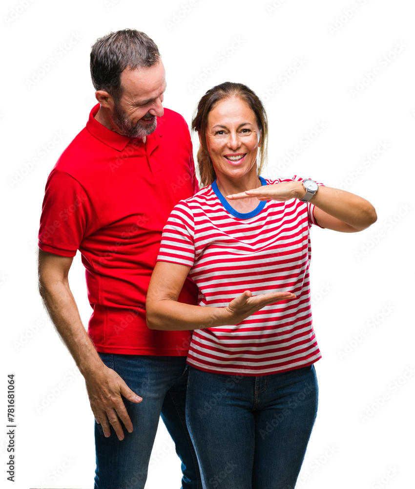 Middle age hispanic couple in love over isolated background gesturing with hands showing big and large size sign, measure symbol. Smiling looking at the camera. Measuring concept. Middle age hispanic couple in love over isolated background gesturing with hands showing big and large size sign, measure symbol. Smiling looking at the camera. Measuring concept.