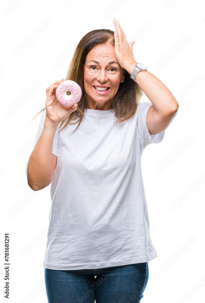 Middle age hispanic woman eating pink donut over isolated background stressed with hand on head, shocked with shame and surprise face, angry and frustrated. Fear and upset for mistake. Middle age hispanic woman eating pink donut over isolated background stressed with hand on head, shocked with shame and surprise face, angry and frustrated. Fear and upset for mistake.
