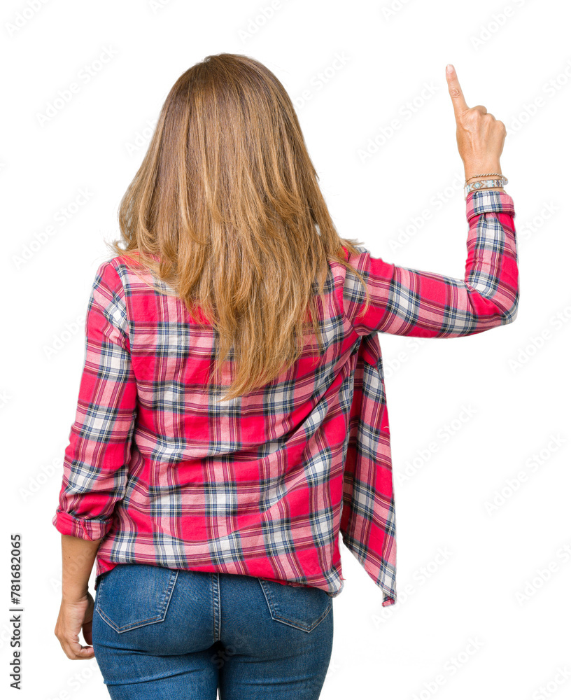 Beautiful middle age woman wearing over isolated background Posing backwards pointing behind with finger hand Beautiful middle age woman wearing over isolated background Posing backwards pointing behind with finger hand