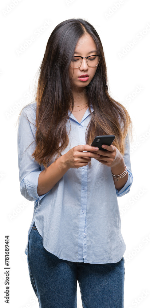 Young asian woman texting using smartphone over isolated background with a confident expression on smart face thinking serious Young asian woman texting using smartphone over isolated background with a confident expression on smart face thinking serious