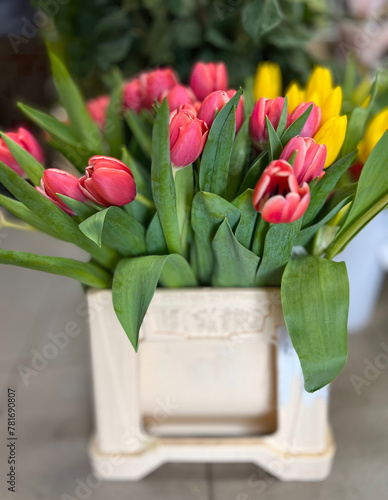 Bouquet of colorful tulip buds. Red and yellow tulip flowers in a decorative flower pot. photo