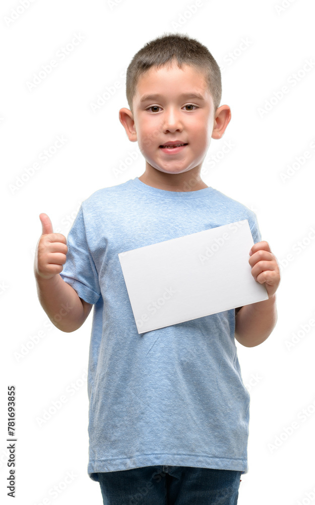 Dark haired little child holding a blank card happy with big smile doing ok sign, thumb up with fingers, excellent sign Dark haired little child holding a blank card happy with big smile doing ok sign, thumb up with fingers, excellent sign