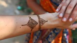 A thin tan line around her left wrist marks the location and significance of the henna tattoo she got on a trip to India. .