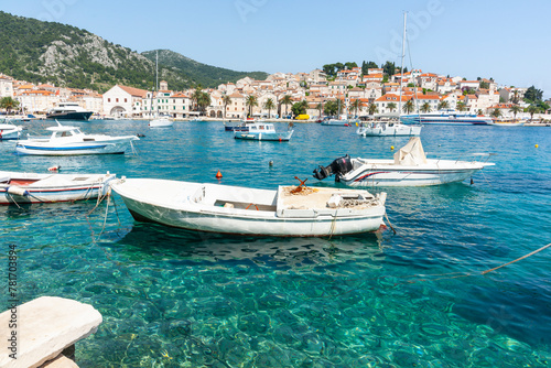 Boats at tied up in harbour with picturesque waterfront and town across bay Croatia © Brian Scantlebury