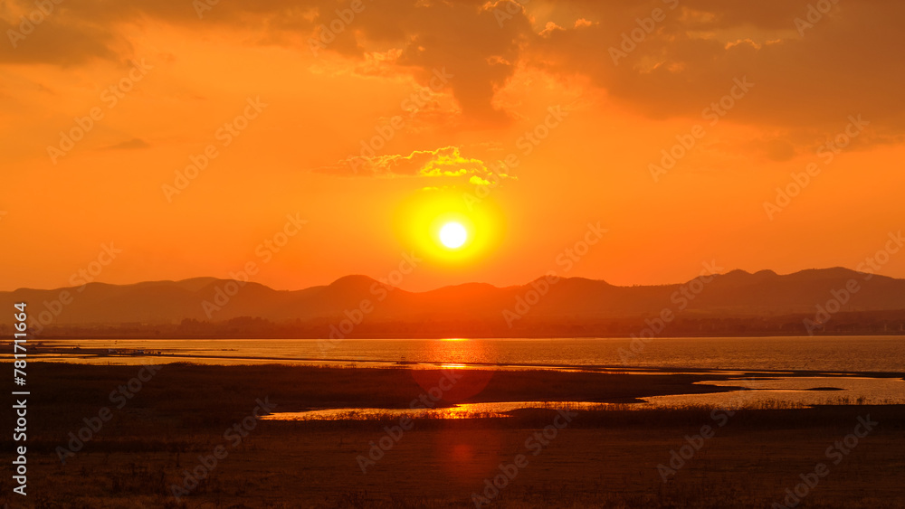 Bright beautiful sunrise or sunset at lake