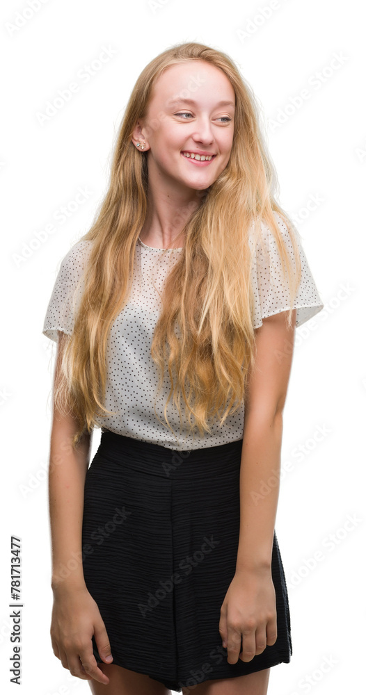 Blonde teenager woman wearing moles shirt looking away to side with smile on face, natural expression. Laughing confident. Blonde teenager woman wearing moles shirt looking away to side with smile on face, natural expression. Laughing confident.