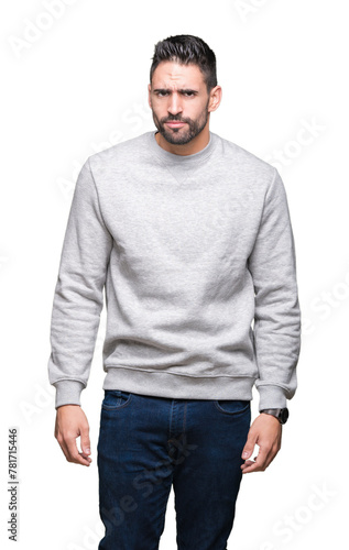 Young handsome man wearing sweatshirt over isolated background skeptic and nervous, frowning upset because of problem. Negative person.