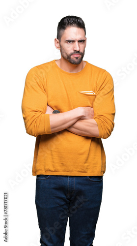 Young handsome man over isolated background skeptic and nervous, disapproving expression on face with crossed arms. Negative person.