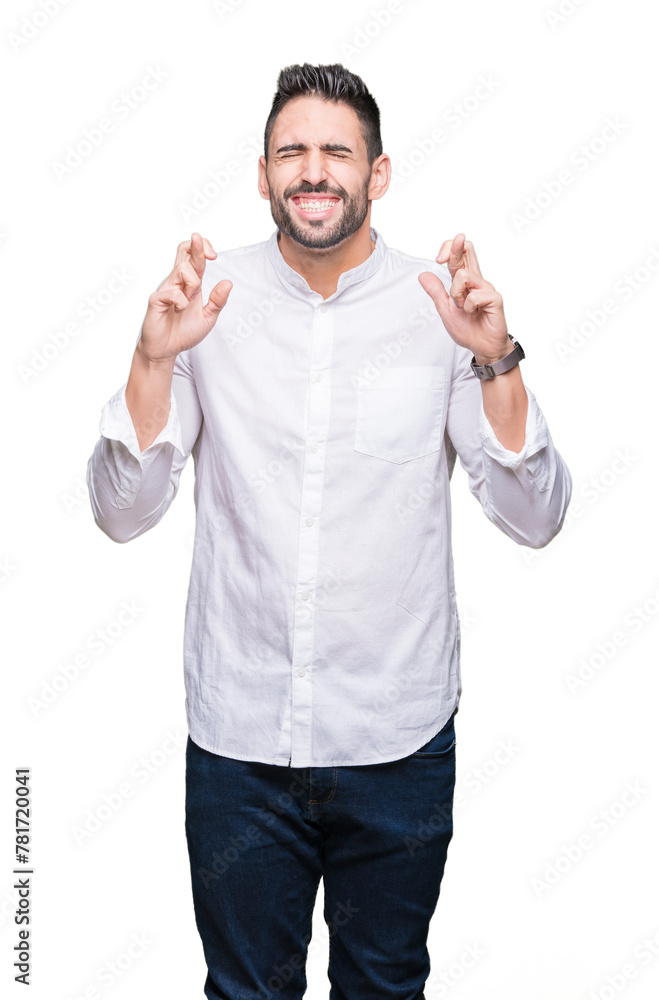 Fototapeta premium Young business man over isolated background smiling crossing fingers with hope and eyes closed. Luck and superstitious concept.