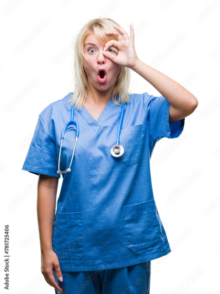 Young beautiful blonde doctor woman wearing medical uniform over isolated background doing ok gesture shocked with surprised face, eye looking through fingers. Unbelieving expression. Young beautiful blonde doctor woman wearing medical uniform over isolated background doing ok gesture shocked with surprised face, eye looking through fingers. Unbelieving expression.