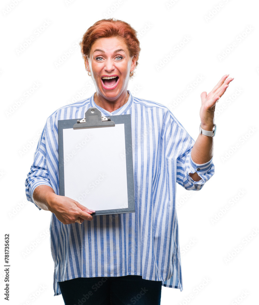 Senior caucasian business woman holding clipboard over isolated background very happy and excited, winner expression celebrating victory screaming with big smile and raised hands Senior caucasian business woman holding clipboard over isolated background very happy and excited, winner expression celebrating victory screaming with big smile and raised hands