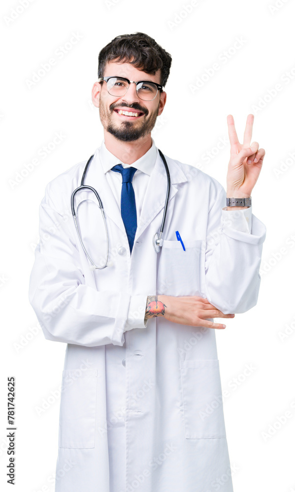 Young doctor man wearing hospital coat over isolated background smiling with happy face winking at the camera doing victory sign. Number two. Young doctor man wearing hospital coat over isolated background smiling with happy face winking at the camera doing victory sign. Number two.