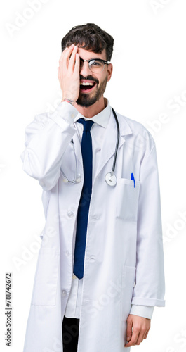 Young doctor man wearing hospital coat over isolated background covering one eye with hand with confident smile on face and surprise emotion.