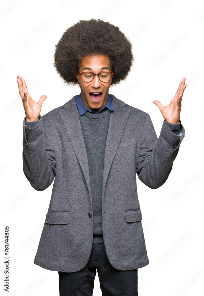 Young african american business man with afro hair wearing glasses celebrating mad and crazy for success with arms raised and closed eyes screaming excited. Winner concept