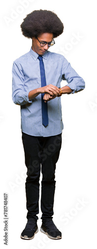 Young african american business man with afro hair wearing glasses Checking the time on wrist watch, relaxed and confident