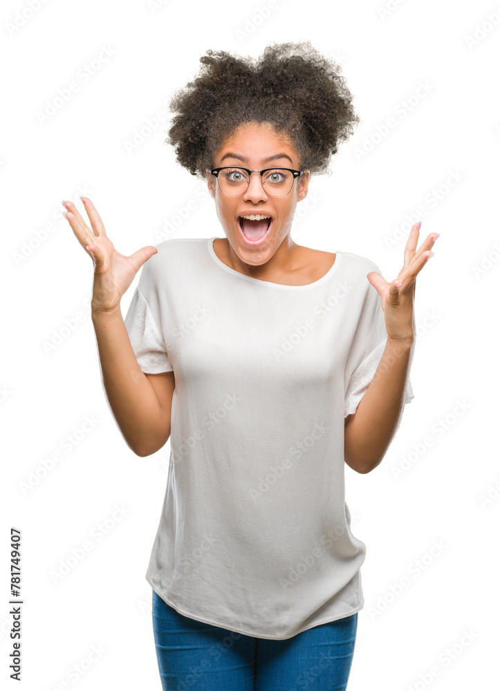 Young afro american woman wearing glasses over isolated background celebrating crazy and amazed for success with arms raised and open eyes screaming excited. Winner concept Young afro american woman wearing glasses over isolated background celebrating crazy and amazed for success with arms raised and open eyes screaming excited. Winner concept