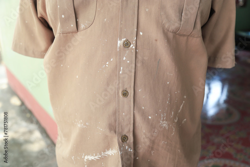 Dirty white color stain on shirt from painting and learning art in school. stains for cleaning concept.
