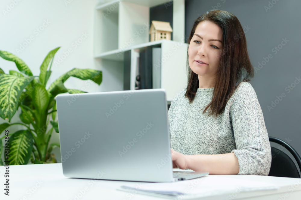 confident woman effectively manages workflow while in a modern equipped office environment. confident woman effectively manages workflow while in a modern equipped office environment.