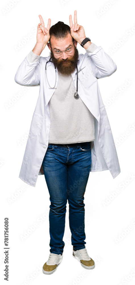Young blond doctor man with beard wearing medical coat Posing funny and crazy with fingers on head as bunny ears, smiling cheerful Young blond doctor man with beard wearing medical coat Posing funny and crazy with fingers on head as bunny ears, smiling cheerful