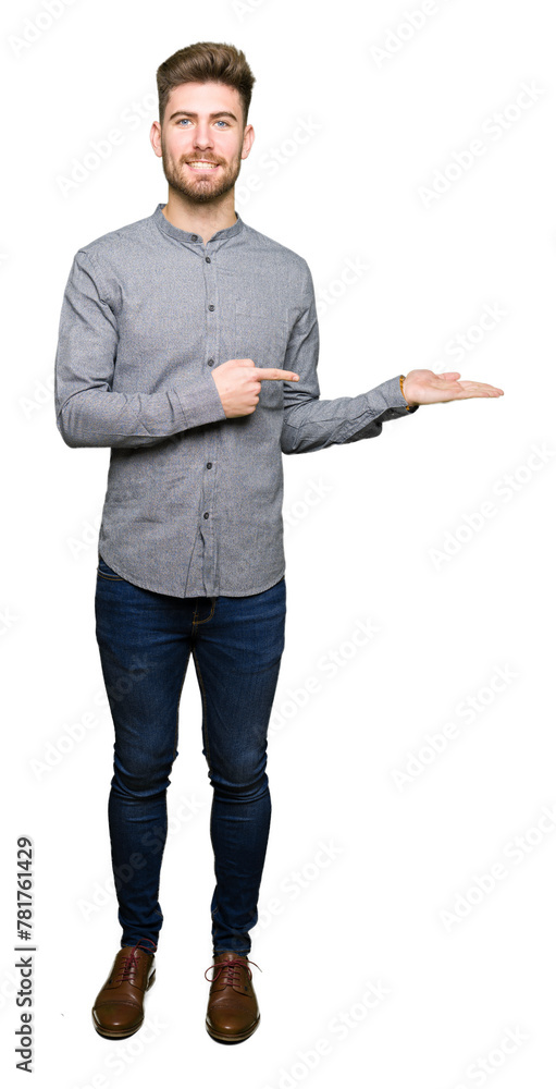 Young handsome business casual man amazed and smiling to the camera while presenting with hand and pointing with finger. Young handsome business casual man amazed and smiling to the camera while presenting with hand and pointing with finger.