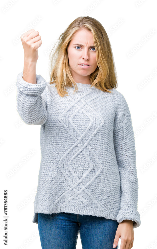 Beautiful young woman wearing winter sweater over isolated background angry and mad raising fist frustrated and furious while shouting with anger. Rage and aggressive concept. Beautiful young woman wearing winter sweater over isolated background angry and mad raising fist frustrated and furious while shouting with anger. Rage and aggressive concept.