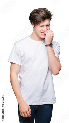 Young handsome man wearing casual white t-shirt over isolated background looking stressed and nervous with hands on mouth biting nails. Anxiety problem.