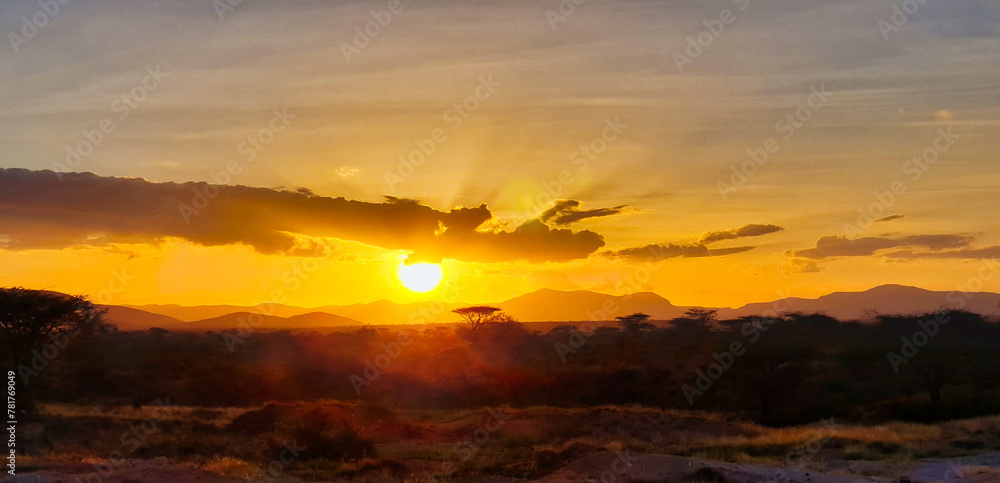 A fiery sunset over the scenic samburu reserve dotted with acacia trees and magnificent wildlife seen here at the Buffalo Springs Reserve in Samburu County, Kenya
