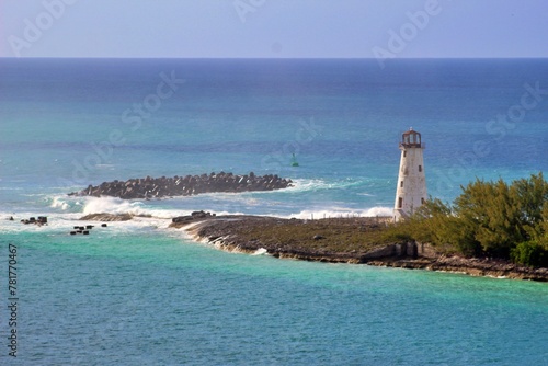 lighthouse stands on peninsula with the Caribbean sea in the background