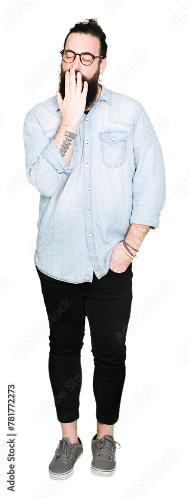 Young hipster man with long hair and beard wearing glasses bored yawning tired covering mouth with hand. Restless and sleepiness. Young hipster man with long hair and beard wearing glasses bored yawning tired covering mouth with hand. Restless and sleepiness.