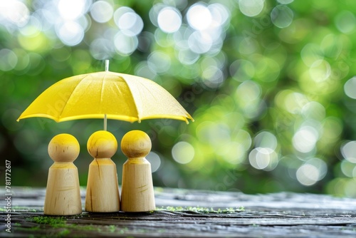 Two people are standing under a yellow umbrella.