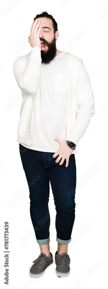 Young hipster man with long hair and beard wearing sporty sweatshirt Yawning tired covering half face, eye and mouth with hand. Face hurts in pain. Young hipster man with long hair and beard wearing sporty sweatshirt Yawning tired covering half face, eye and mouth with hand. Face hurts in pain.