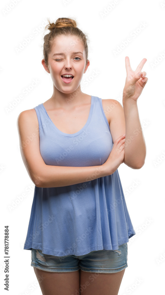 Young blonde woman smiling with happy face winking at the camera doing victory sign. Number two. Young blonde woman smiling with happy face winking at the camera doing victory sign. Number two.