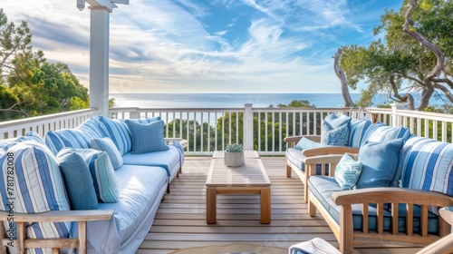 Stepping out onto the balcony of this coastal retreat you are greeted with stunning views of the beach and ocean. The sandycolored deck furniture paired with blue and white striped . photo