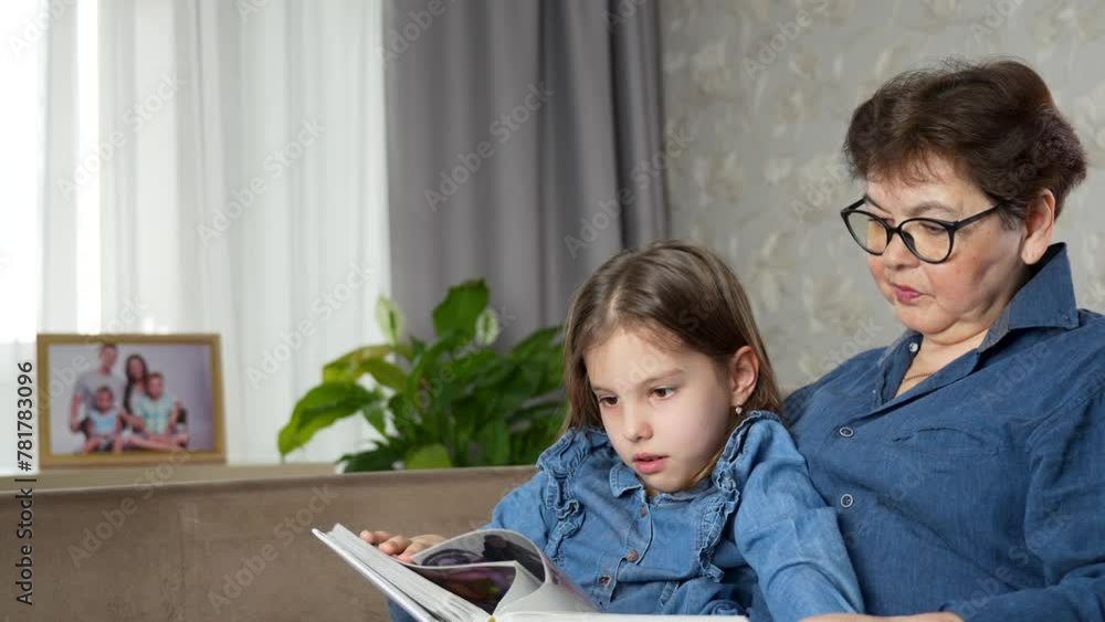 Portrait of 60 years old grandmother with her little grandchild, reading book Portrait of 60 years old grandmother with her little grandchild, reading book